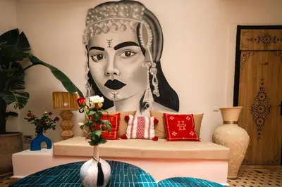 a room with a large portrait of a woman at Riad Le Soleil de Bahia in Marrakech