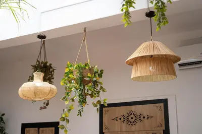 two hanging pendant lights in a room with plants at Riad Le Soleil de Bahia in Marrakech