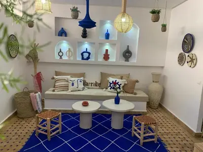 a living room with a couch and two chairs at Riad Le Soleil de Bahia in Marrakech