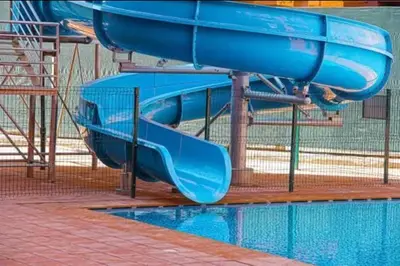 a blue water slide in a swimming pool at Bel Appartement Vue Piscine in Marrakech