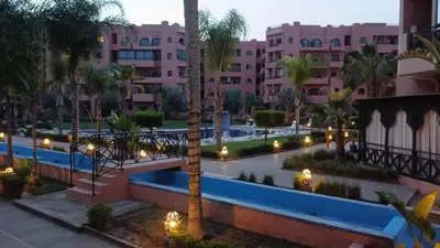 a view of a resort with a pool and buildings at Bel Appartement Vue Piscine in Marrakech
