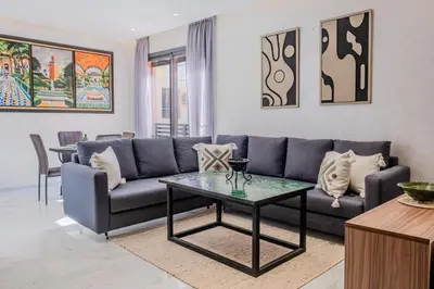 a living room with a couch and a table at Charming Apartment in Hyper Center Modernity in Marrakech