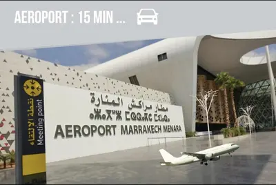 an airplane is parked in front of a building at Modern Place in Marrakech