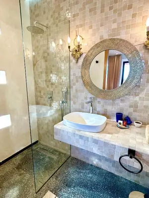 a bathroom with a sink and a mirror at Palais Celeste in Marrakech