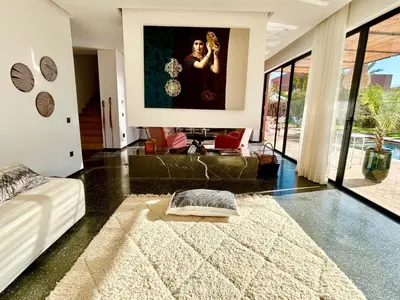 a living room with a large painting on the wall at Palais Celeste in Marrakech