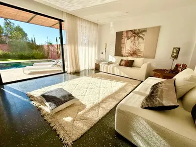 a living room with a bed and a couch at Palais Celeste in Marrakech
