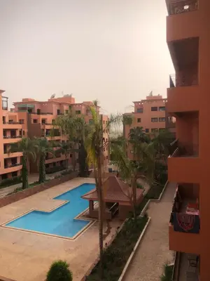 a swimming pool in the middle of a building at Résidence Babylone Y - 2 Bedrooms Appartement in Marrakech