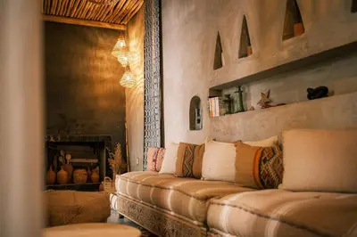 a couch in a living room with a fireplace at Riad en exclusivité Maison Habibi in Marrakech