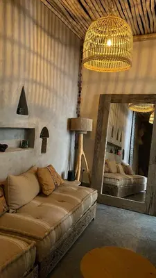 a living room with a couch and a mirror at Riad en exclusivité Maison Habibi in Marrakech