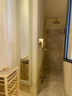 a bathroom with a shower and a mirror at Riad en exclusivité Maison Habibi in Marrakech