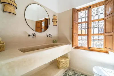 a bathroom with a large tub and a mirror at Riad Sofia Marrakech in Marrakech