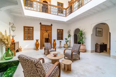 a living room with chairs and a table at Riad Sofia Marrakech in Marrakech