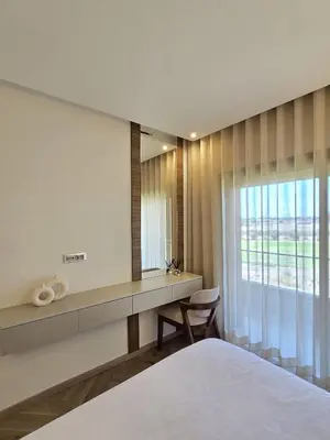 a bedroom with a bed and a desk and a window at Sublime Apartment at Prestigia Golf, Marrakech in Marrakech