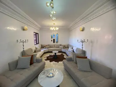 a living room with a couch and a table at Warda 2 Bedroom Hivernage Apartment in Marrakech