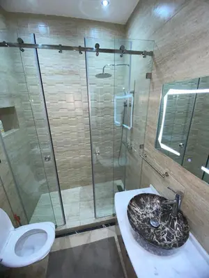 a bathroom with a shower and a toilet and a sink at Warda 2 Bedroom Hivernage Apartment in Marrakech
