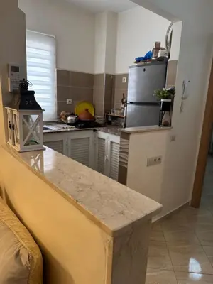 a kitchen with a counter top and a refrigerator at A bright and airy living room in Marrakech