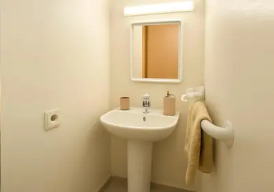 a small bathroom with a sink and a mirror at Gate 3 in Marrakech