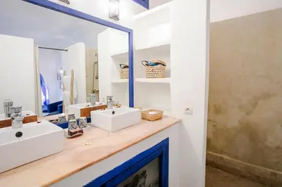 a bathroom with two sinks and a mirror at Riad LOU, 5 bedrooms, private 12 p, pool, hammam in Marrakech