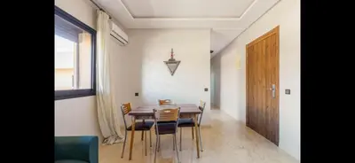 a dining room with a table and chairs and a door at Nor in Marrakech