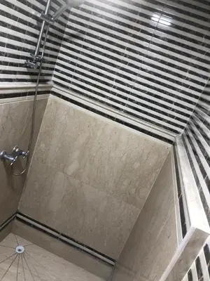 a shower with a glass door in a bathroom at Résidence Babylone Y - Appartement 2 Chambres in Marrakech