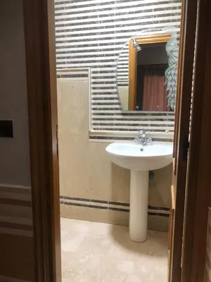 a bathroom with a sink and a mirror at Résidence Babylone Y - Appartement 2 Chambres in Marrakech