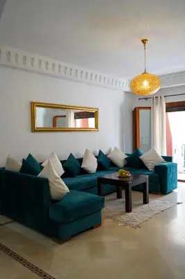 a living room with a blue couch and a table at Plaza Julianah in Marrakech
