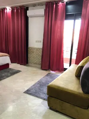 a living room with red curtains and a couch at - Résidence Babylone Y - 3 Bedrooms Appartement in Marrakech