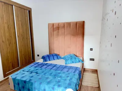 a bedroom with a bed and a large window at Gueliz flat centre in Marrakech