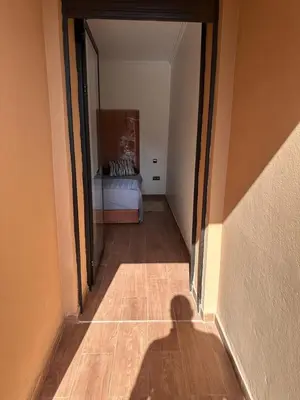 a shadow of a person standing in a hallway with a bed at Gueliz flat centre in Marrakech