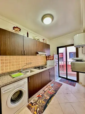 a kitchen with a sink and a washing machine at spacieux appart familial avec 2 chambres in Marrakech