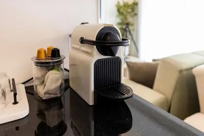 a coffee maker sitting on top of a table at Escapade relaxante au Domaine NORIA in Marrakech