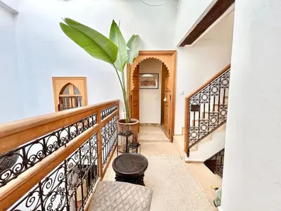 a staircase in a house with a potted plant at Riad Fleur de Kasbah in Marrakech