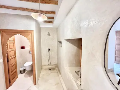 a bathroom with a toilet and a mirror at Riad Fleur de Kasbah in Marrakech