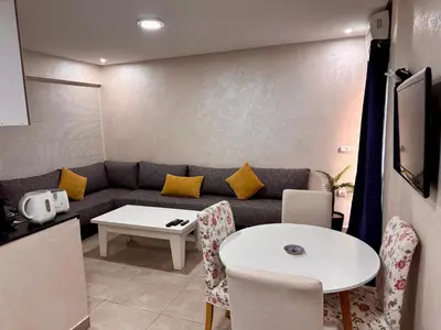 a living room with a couch and a table at New Résidence Miramas 2 in Marrakech