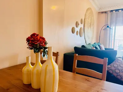 three yellow vases sitting on a wooden table with a flower at New Résidence Miramas 2 in Marrakech