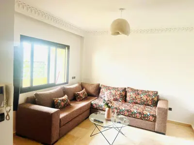 a living room with a couch and a table at New Résidence Miramas 2 in Marrakech
