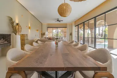 a dining room with a wooden table and chairs at Villa Bali Amelkis in Marrakech