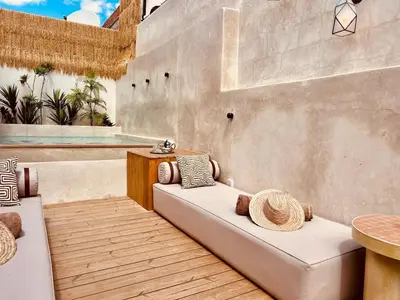 a patio with a couch and a table at Riad Casa Léa - Bassin chauffé - Petits déjeuners in Marrakech