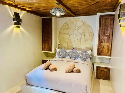 a bedroom with a bed with two pillows on it at Riad Casa Léa - Bassin chauffé - Petits déjeuners in Marrakech