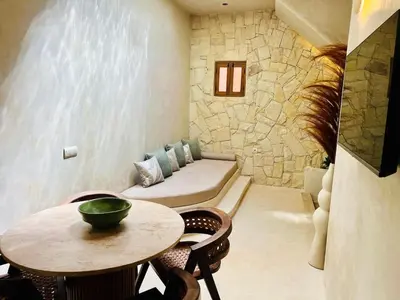 a living room with a couch and a table at Riad Casa Léa - Bassin chauffé - Petits déjeuners in Marrakech