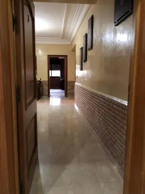 an empty hallway with a tile wall and a door at - Résidence Babylone Y - Appartement 3 Chambres in Marrakech