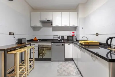 a kitchen with white cabinets and a counter top at Évasion aux portes de Majorelle in Marrakech