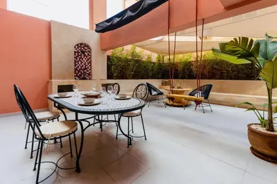 a dining room with a table and chairs at Évasion aux portes de Majorelle in Marrakech