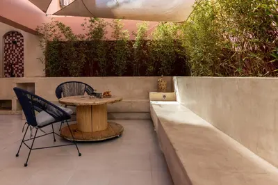 a patio with a table and chairs on a patio at Évasion aux portes de Majorelle in Marrakech