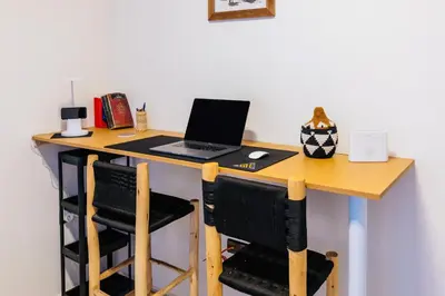 a desk with a laptop computer on top of it at Évasion aux portes de Majorelle in Marrakech