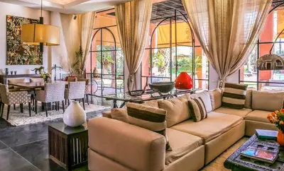 a living room with a couch and a table at Villa Jardin Nomade in Marrakech