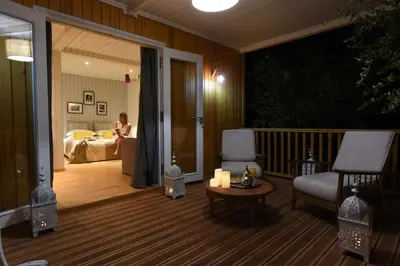 a room with a balcony with a bed and a woman at Villa Jardin Nomade in Marrakech