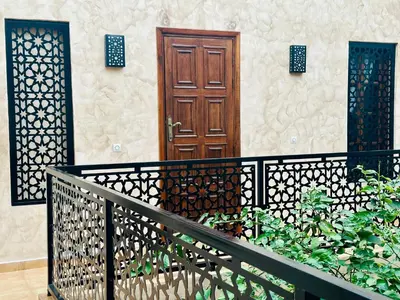 a house with a wooden door and a fence at 66 Dar Aarab - Marrakech in Marrakech