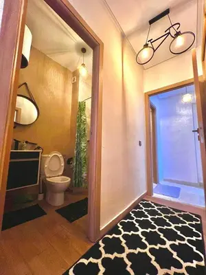 a bathroom with a toilet and a door with a plant at séjournée chez mayaa in Marrakech