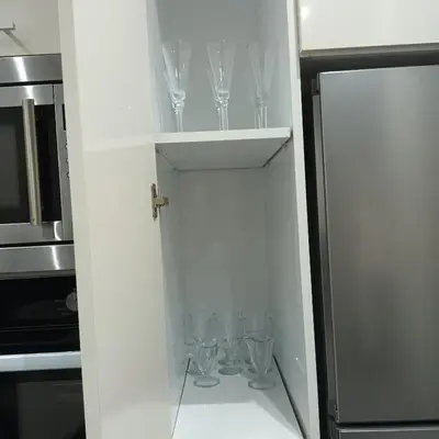 a kitchen with wine glasses in a cupboard at Modern 2-Bedroom Family Flat in Central Marrakech in Marrakech